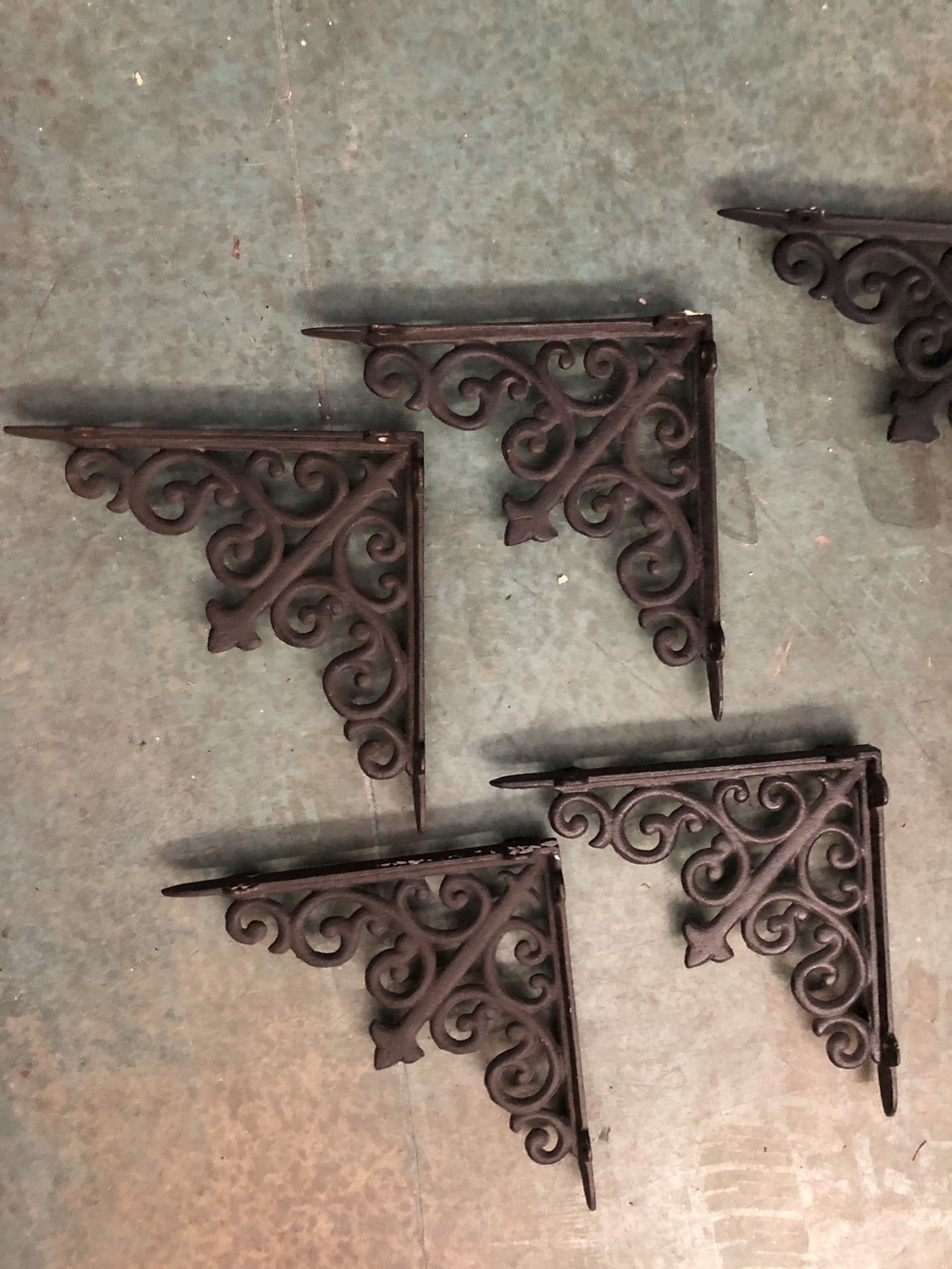Shelf brackets. Four dark brown and two black. Wrought iron very solid