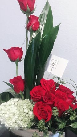 Red roses arrangement in silver vase
