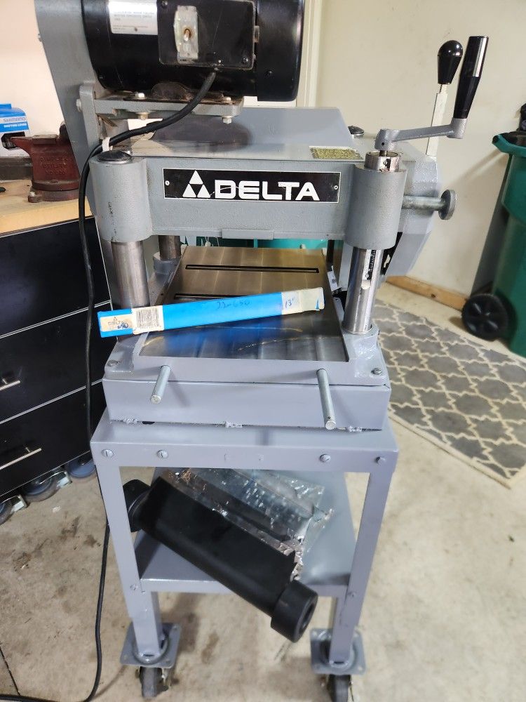 Delta Invicta 13 inch planer with extra blades and mobile base.