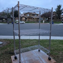 three-tier chrome-plated steel wire shelving unit with casters. 