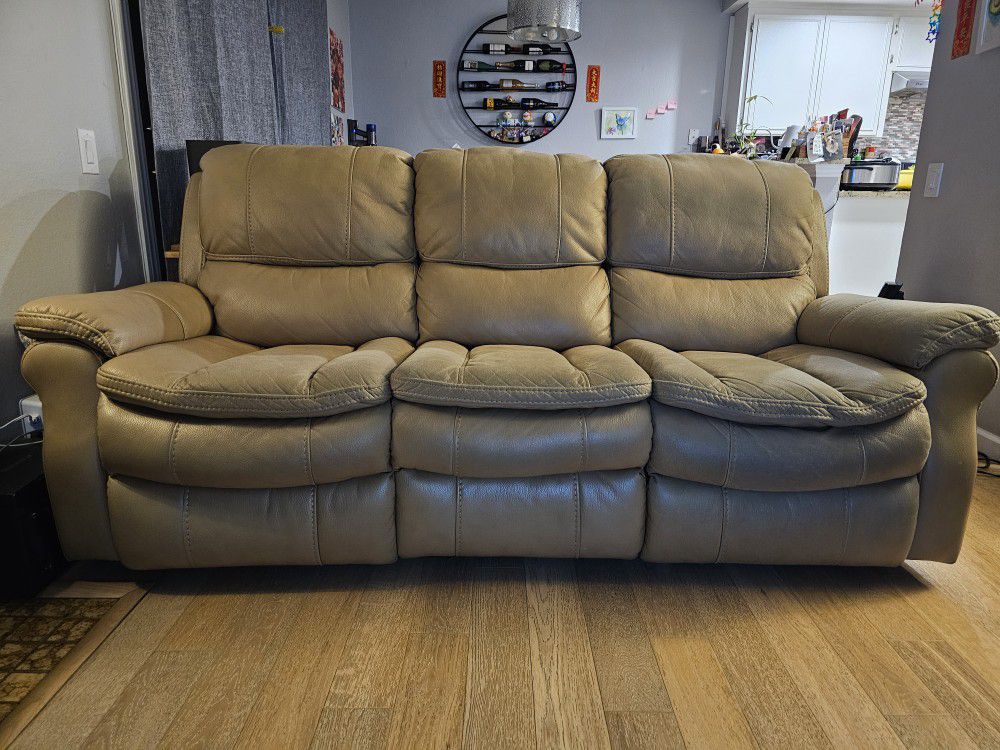Living Space - Beige color 85" Reclining sofa.