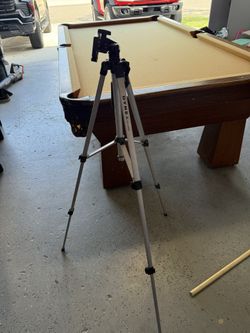 Tripod.  Great for Both Cameras And Videos As It Rotates With Handle. $10