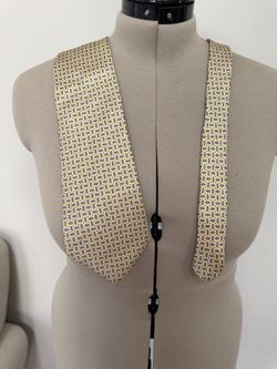 yellow silk necktie from Lauren Ralph Lauren featuring a blue and white geometric pattern.