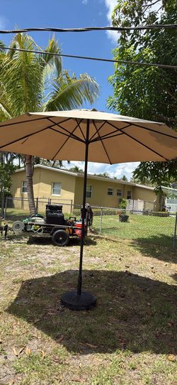 Patio shade umbrella with 60 pound stand &150 or best offer