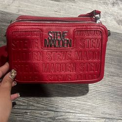 Steve Madden red logo-pressed crossbody camera bag.