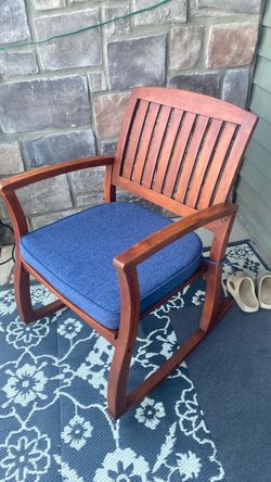 Two wooden rockers with cushions