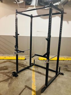 Squat rack cage, dip bars, 2’ and 1’ landmine, safety arms, attached weights racks and pull-up bar, J-Hooks