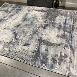 {ONE} Dowdey abstract gray area rug - 6’7” x 9’ rectangle. Material: polyester; polypropylene. Slight edge wear. MSRP: $250. Our price: $163 + Sales t