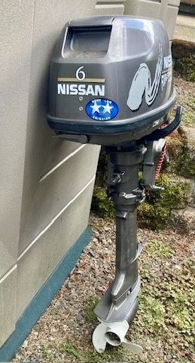 Nissan 6 horsepower 4-stroke motor with auxiliary fuel tank and fuel line. 15” shaft
