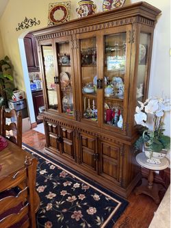 Pecan dining room table with 8 chairs and matching hutch