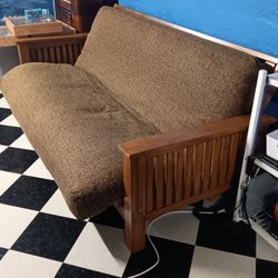 Futon couch bed oak frame. About a double bed when its down.23 mile and Card Macomb Township Michigan 