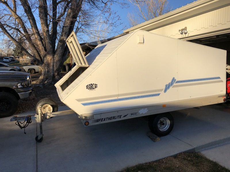 Enclosed Featherlite snowmobile trailer with Bearcat cover