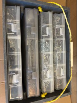 4 boxes containing miscellaneous nails screws, fasteners, and hardware