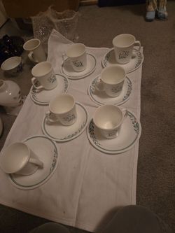  Rosemarie features a floral design with pink tulips and green leaves, often with a green band around the rim. 