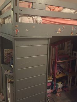 Twin loft bed with staircase, drawers, and built-in desk