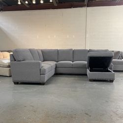 Gray sectional couch with storage ottoman