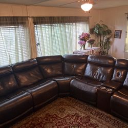 Leather sectional sofa with reclining feature