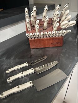 Brand new bought at $4700 High-quality CUTCO knife set. Has a wooden knife block with many knives with white handles and black stripes. Also includes 