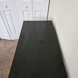 Black desk with metal pegs