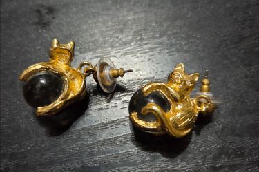 Cat sitting atop a marble earrings