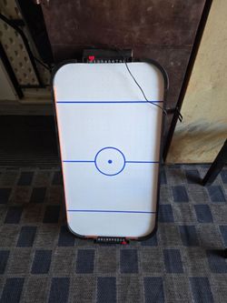 Electric table top air hockey game