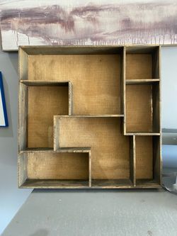 Tetris asymmetrical wooden wall shelf featuring a rustic wood frame and a burlap-lined backing with multiple compartments