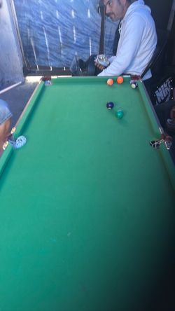 Pool table miniature with two pool sticks and balls