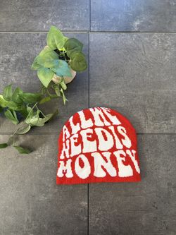 Red and white All We Need Is Money beanie