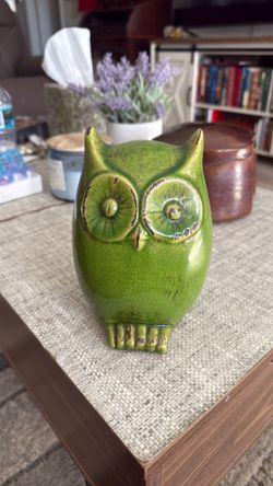 A vintage green glazed ceramic owl figurine with a crackled finish.
