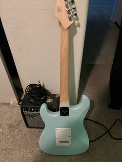 Squier stratocaster electric guitar and amp.