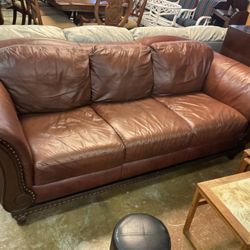 Brown leather couch and loveseat