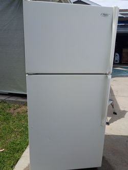 White apartment size refrigerator with ice maker