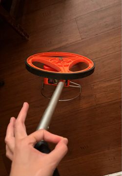 This is a Lufkin measuring wheel, color Orange