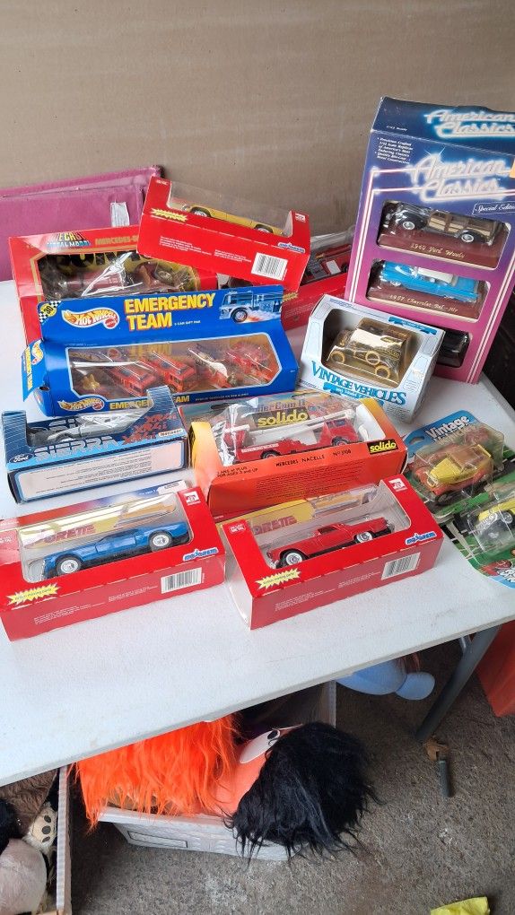 collection of older toy cars in packages