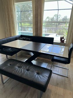 European dining table set, purchased in Germany. Modern, stylish design with black glass top and matching black leather benches/chairs.