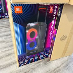 Powerful JBL PartyBox Stage 320 speaker. New in box. This portable speaker has an adaptive light show, Bluetooth, telescopic handle and wheels, and is