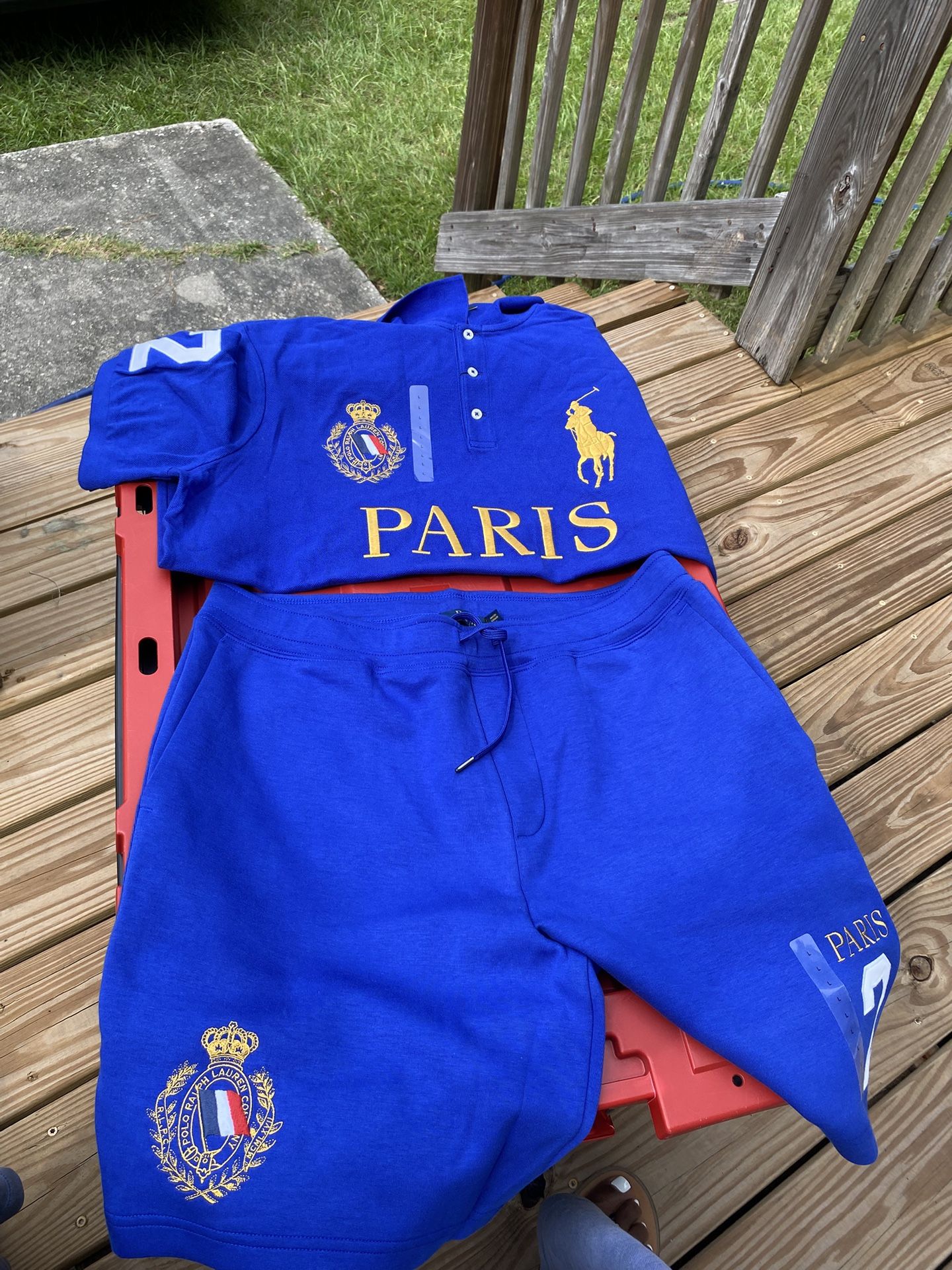 In the blue outfit is a size large $100. The white outfit with the gold writing on it is $60. The green outfit is $150. The gray shirt is $75. The mot