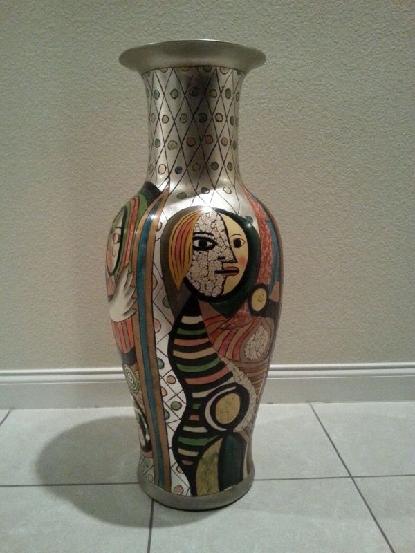 A LARGE CERAMIC FOUR FACE VASE