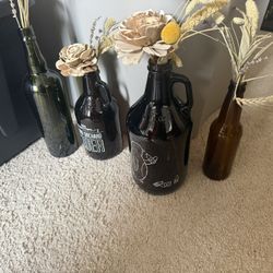 Flower Arrangements In Various Bottles