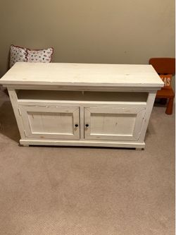 Distressed white media cabinet