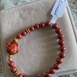Beautiful red cinnabar bracelet with lucky cat charm
