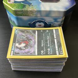 Stack Of Holographic Pokemon Cards and Snorlax Pokemon Go Tin