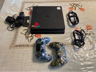 PS4 console with charging station and 12 games