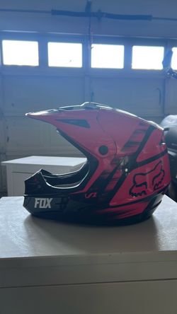 Fox pink and black motorcycle helmet