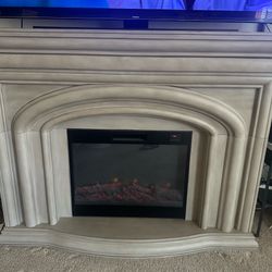 Electric fireplace w/heating , 4 ft height , top is 5 ft. 2 in, x 15.75 in . Works great , has remote