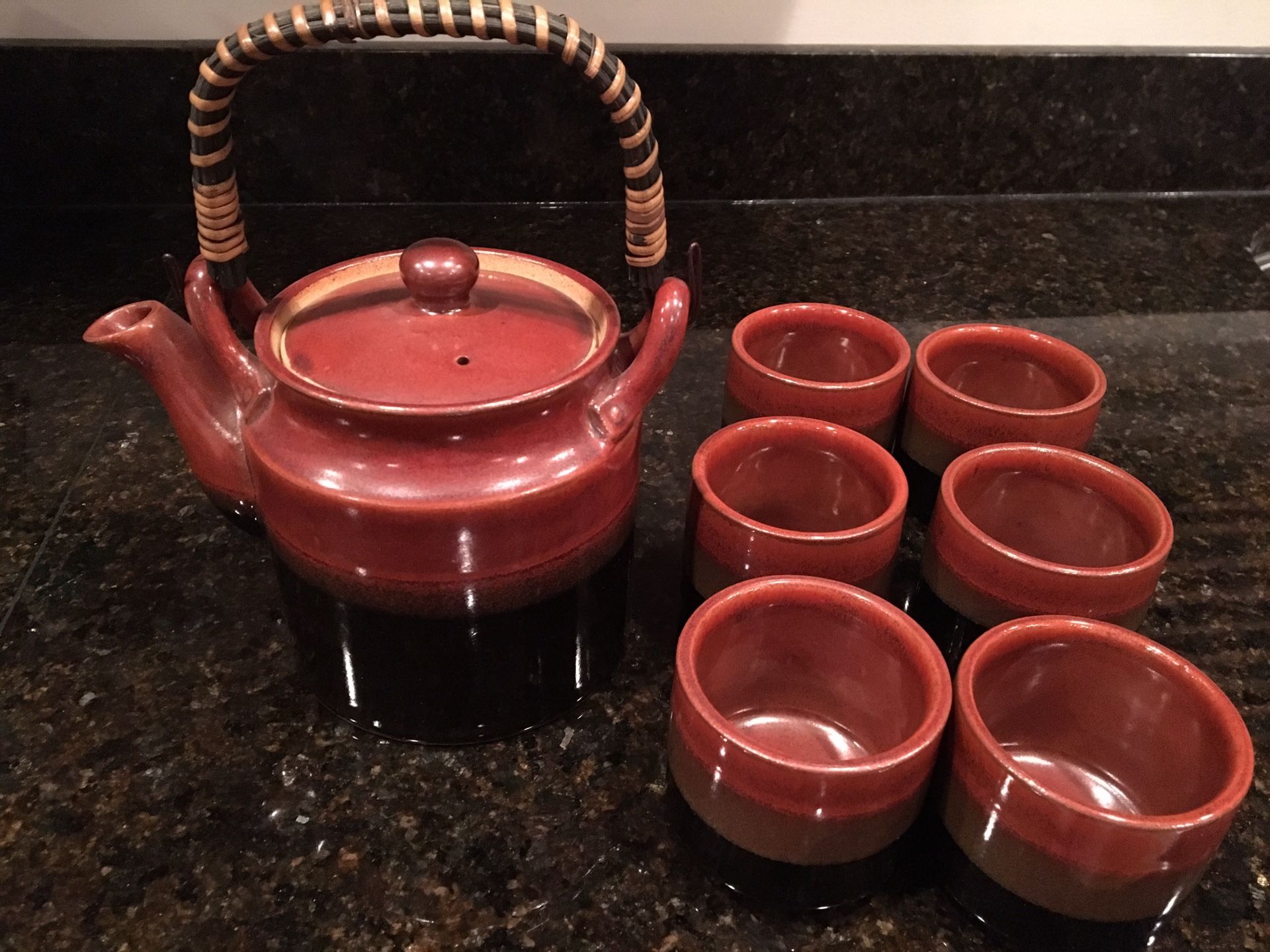 Teapot with 6 tea cups with black border around bottom of teapot and cups. New, never used. $12-