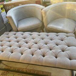 Two gray upholstered, living room, chairs, and one ottoman. Living room chairs have slip covers that can be removed washed and or died. they’re in goo