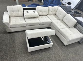 Silver / Gray Fabric Reversible Sectional With Cup Holder And Storage Ottoman. Brand New.