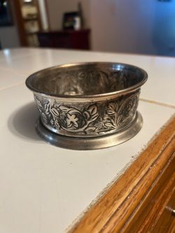vintage Pottery Barn Pewter Wine Bottle Coaster from the Madena Collection, featuring an embossed grape and leaf motif with a hammered finish.