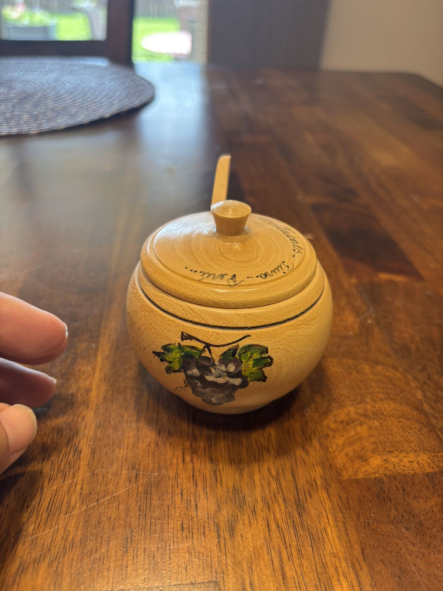 Vintage wooden honey pot with a lid and a small wooden dipper from Peru